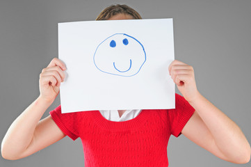 Girl hiding behind happy face