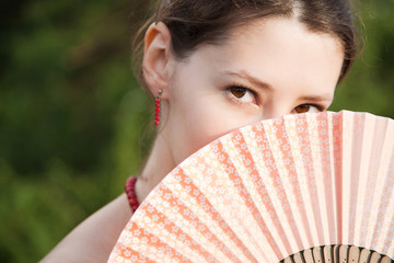 Brunette with a fan