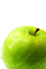 Granny smith apple splashed with water