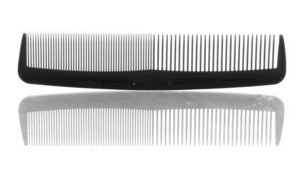 black plastic hair comb with reflection on white background
