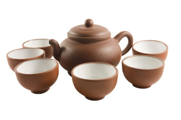 Chinese tea set surrounded by tea cups (Isolated)