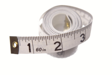 Tape measure rolled on white background