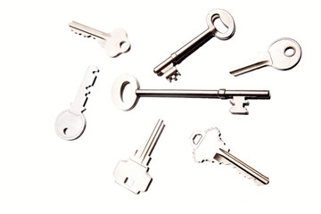 Seven assorted keys on white