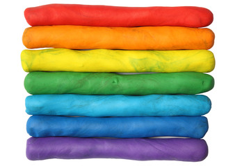 Rainbow colors plasticine play dough isolated over white.
