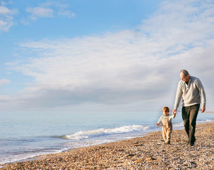 father and son walking on beach