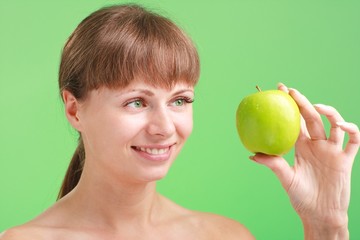 Smiling woman with green apple