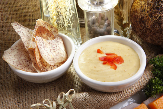 Fried Malanga chip slices with cheese and sausage dip