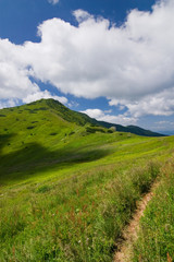Mountain-ridge and blue sky with white clouds