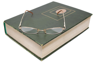 Glasses lying on an old book