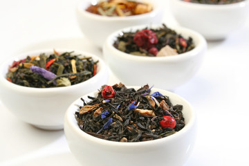 Various bowls of premiun tea leaves blends, over white