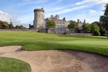 close up of golf sand bunker by golf green and castle