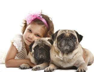 little girl with two dods breed pug
