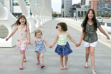 Four little girl group walking in the city