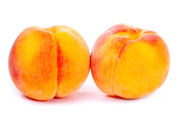 Two ripe peaches isolated on white background