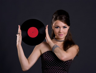 Pretty woman with gramophone record