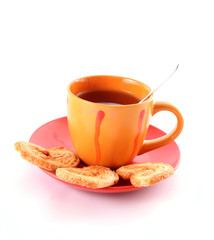 Cup of green tea on the saucer with cookies