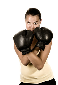 Cute girl in black boxing gloves isolated - sepia toned image