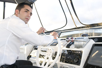 elegant man at yatch control