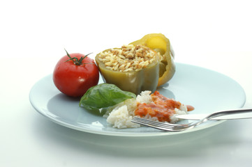 Green mince filled paprika with basil leaf and tomato