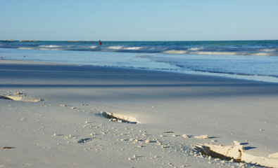 Footprints going over a sand beach