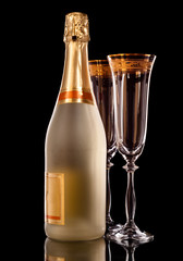 Bottle of Champagne and two empty champagne glasses