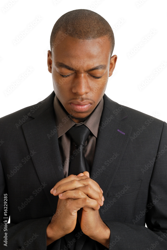 Wall mural business man praying with eyes closed