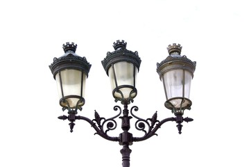 Fototapeta na wymiar Three old-fashioned lamps on white