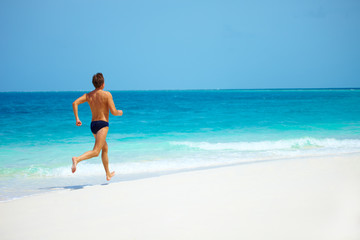 the running person on a coast of ocean