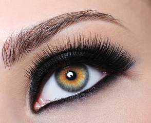 Female eye with black long eyelashes