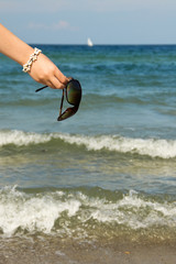 Hand holding sunglasses