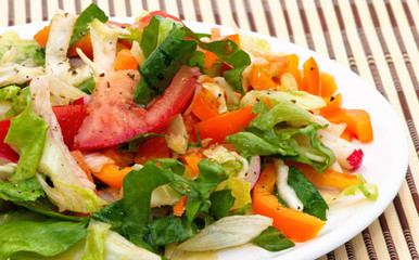 Fresh vegetable salad from tomatoes, paprika and latuce