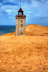 Fototapeta na wymiar Lighthouse in the sand dunes of Rubjerg Knud