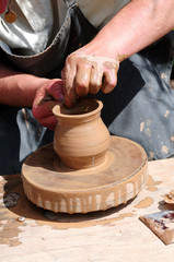 Potter working on a lathe to create a pot
