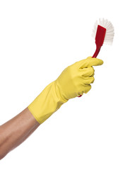 Hand with a yellow protection glove holding a dish-brush