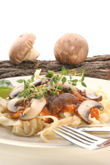 Pasta with mushroom and organic herbs on a plate