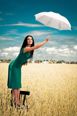 girl with an umbrella in the field