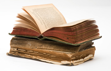 Stack of Old frayed books isolated over white background