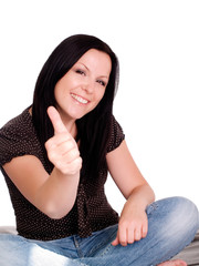 smiling brunette woman with her thumb up over over white