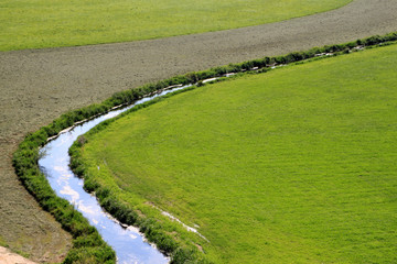 Bachlauf inmitten von saftigen Wiesen