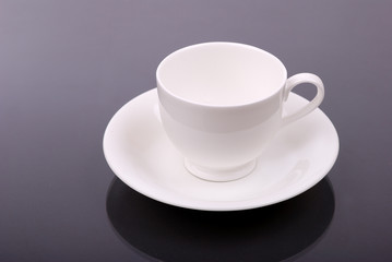 White porcelain cup on a grey