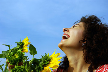Laughing pretty girl with a sunflower