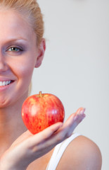 Close-up of an attractive woman holding apple