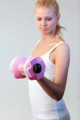 Portrait of a woman trained with weights focus on weights