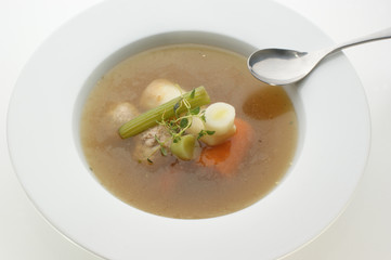 healthy soup with organic vegetables and a spoon