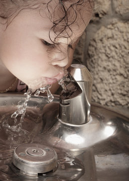 Girl Drinking From A Water Fountain