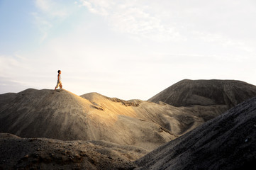 young man go up in sand desert