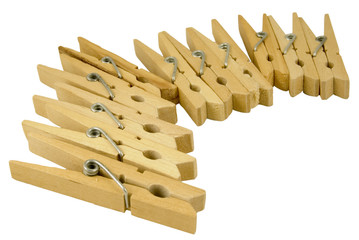 curve of wooden clothes pegs isolated on white background