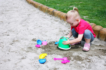 Little girl playing in the sand