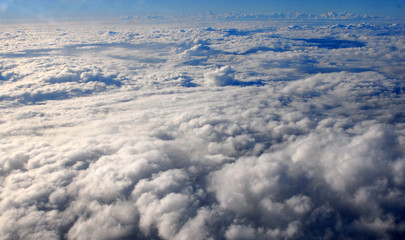 Naklejka na ściany i meble Above clouds, view from plane