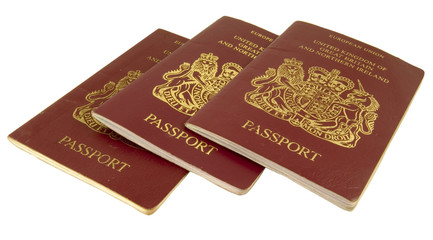 three british passports isolated on white background